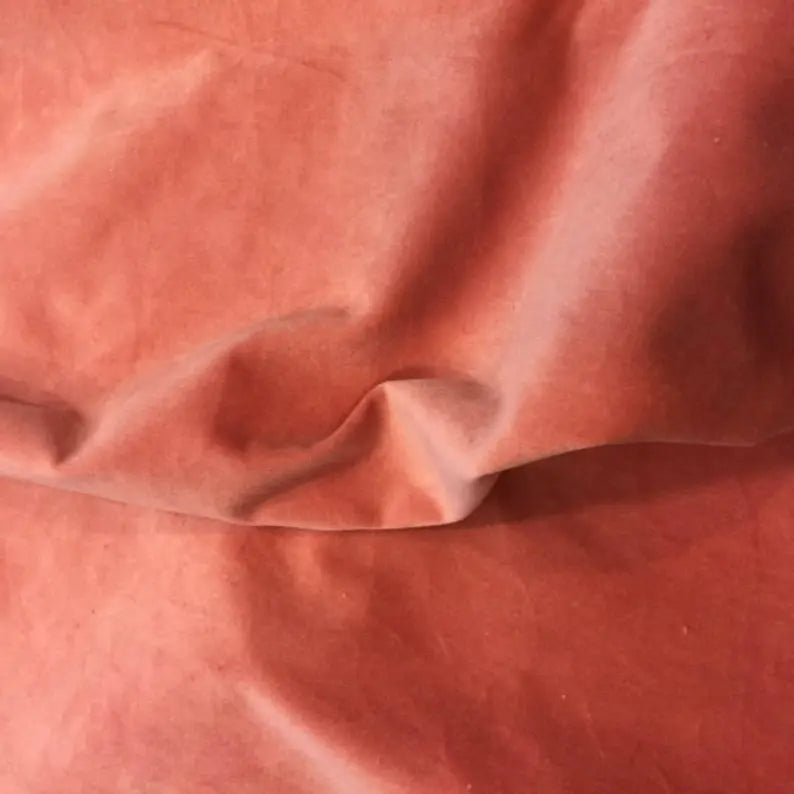 Wrinkled rust-red cotton fabric, ideal for upholstery and crafting projects.