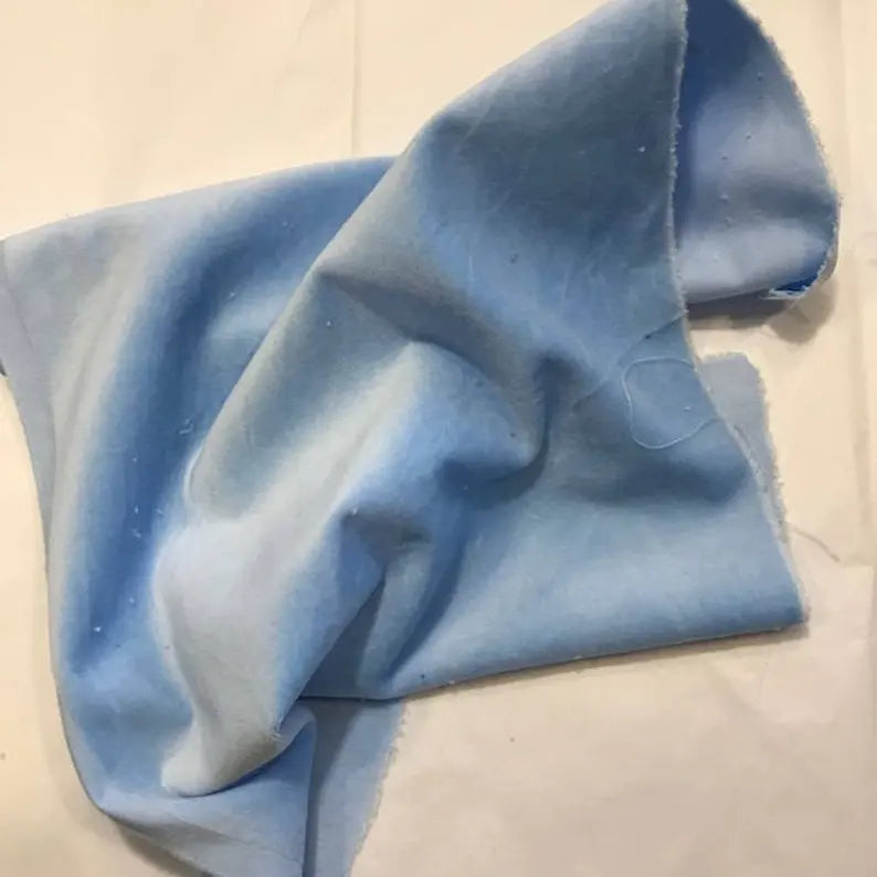 Light blue fabric, soft cotton material, ideal for crafting and sewing projects.