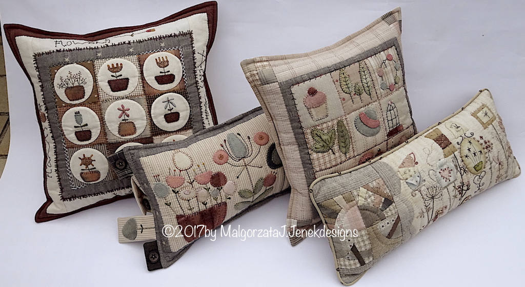 Set of four decorative quilted pillows in natural tones, featuring floral and plant designs.