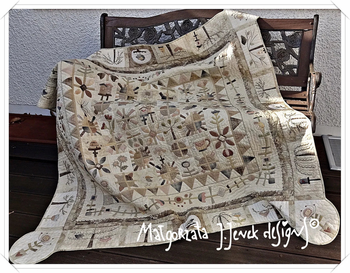 Handcrafted quilt with floral patterns in neutral tones, made of high-quality cotton for cozy warmth.