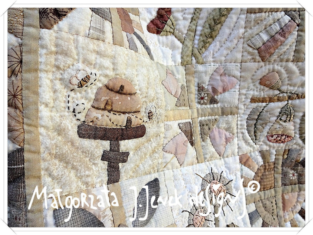 Handcrafted quilt featuring a beehive design in warm beige tones, made from high-quality fabric.