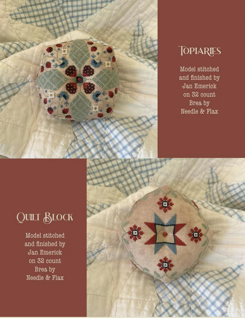 Two decorative, stitched pincushions on a quilt; Topiaries and Quilt Block, 32 count linen, by Jan Emerick.