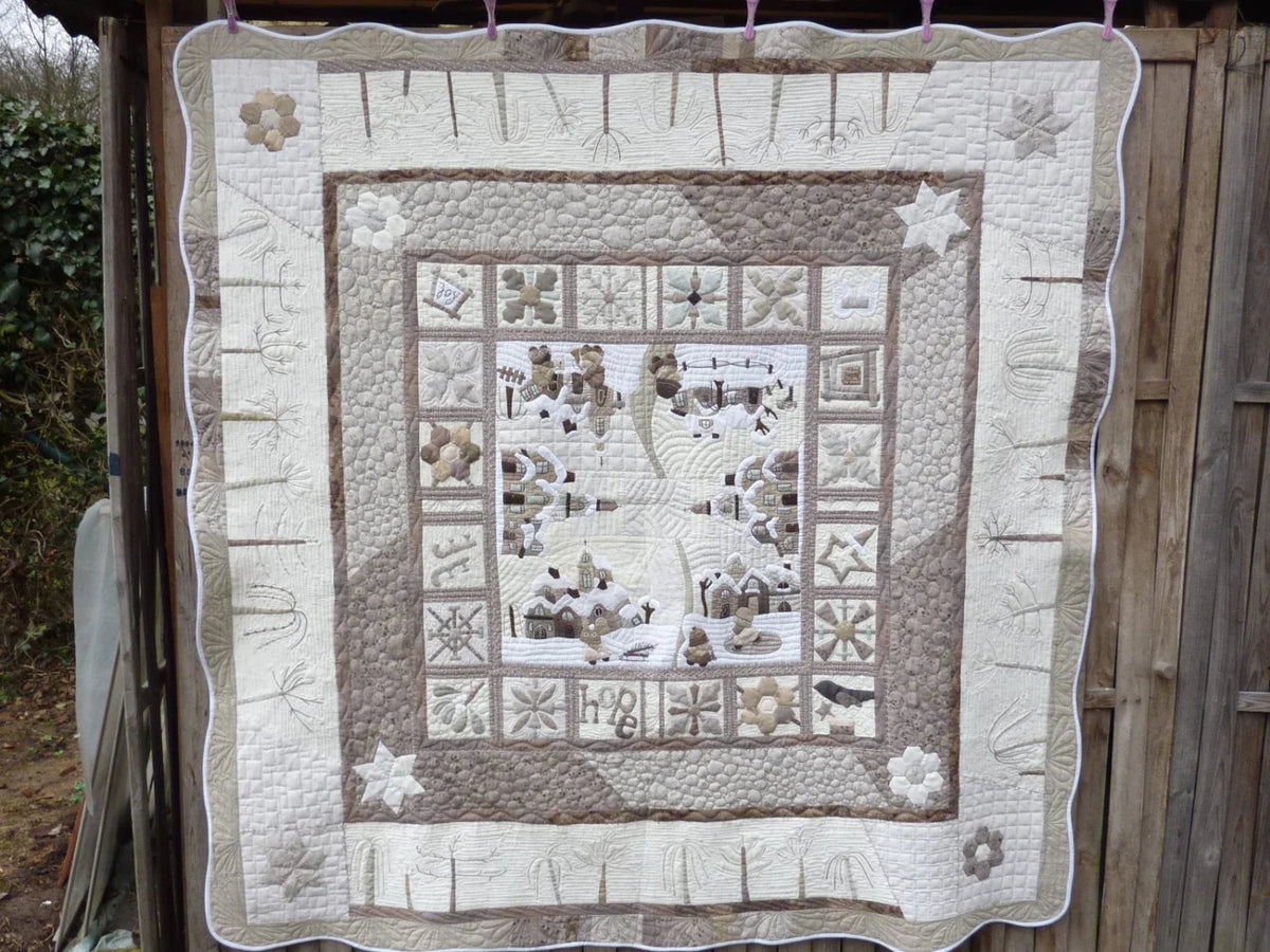 Handcrafted quilt in earthy tones featuring intricate patterns and a cozy design, perfect for home decor.