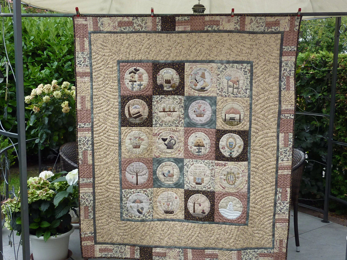 Vintage quilt featuring nature motifs, earthy tones, intricate stitching, and cozy patchwork design.