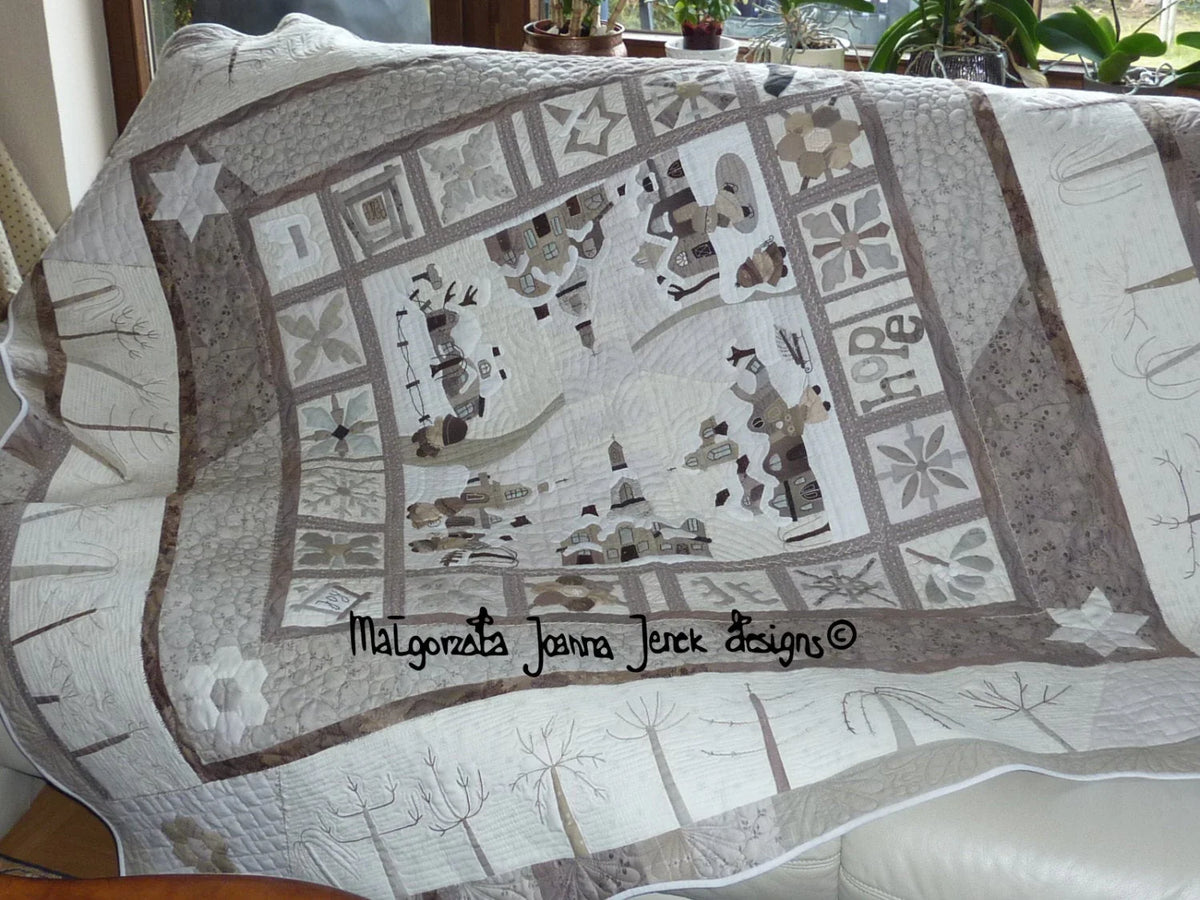 Handmade quilt featuring a soft beige and brown design with charming countryside scenery and floral patterns.