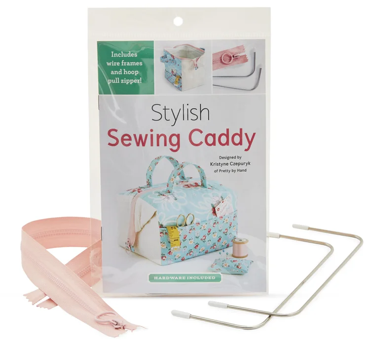 Stylish sewing caddy kit with wire frames, hoop zipper, and pink fabric elements, perfect for organization.
