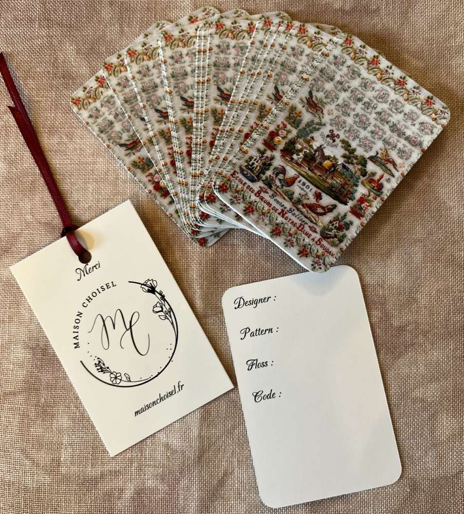 Decorative embroidery pattern cards with floral design, featuring designer tag and color guide.