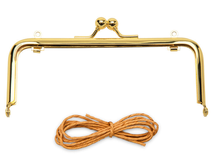 Gold metal handbag frame with two balls and brown cord for crafting purses and bags.
