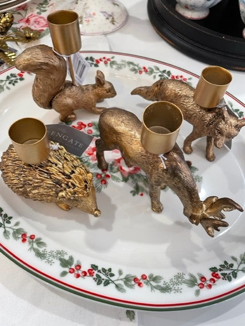 Set of four woodland animal candle holders in gold finish: squirrel, fox, hedgehog, and deer.